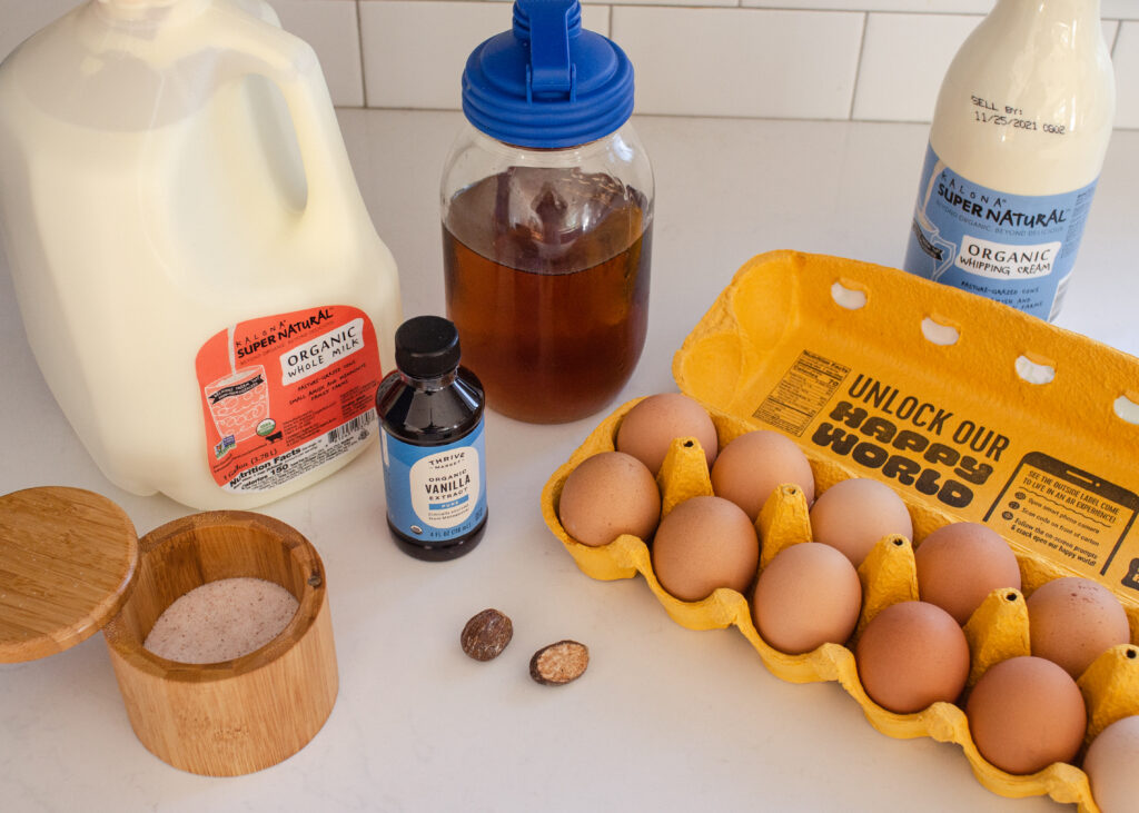 All of the ingredients needed to make cooked eggnog laid out on a counter.