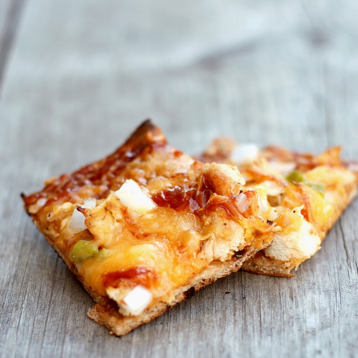 Two slices of pizza on a wooden surface.