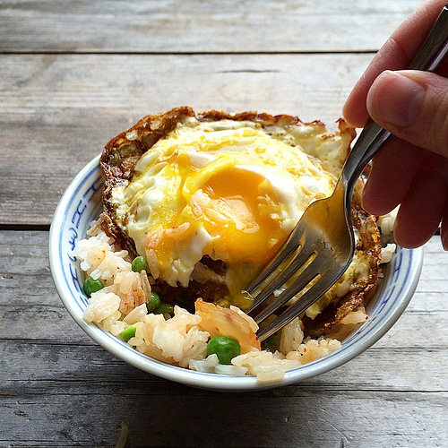 Crispy egg (method via @debperelman ) over kimchi rice for lunch. #smittenkitchen