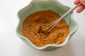 Whisking together all of the ingredients in a small bowl.