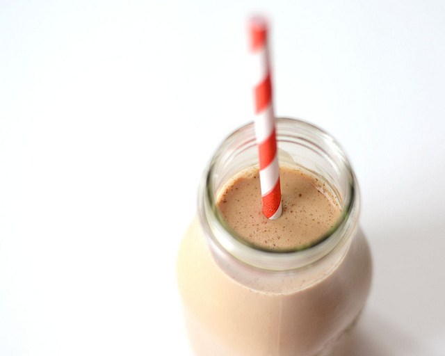 A jar of homemade Starbucks bottled Frappuccino on a white counter with white subway tile backsplash in the background. 