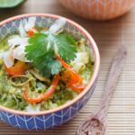 A bowl of coconut chicken curry soup over rice.