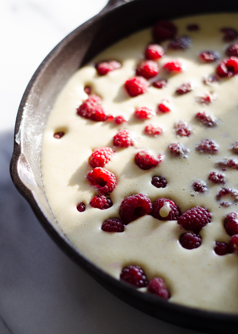 The batter poured over the berries in the pan.