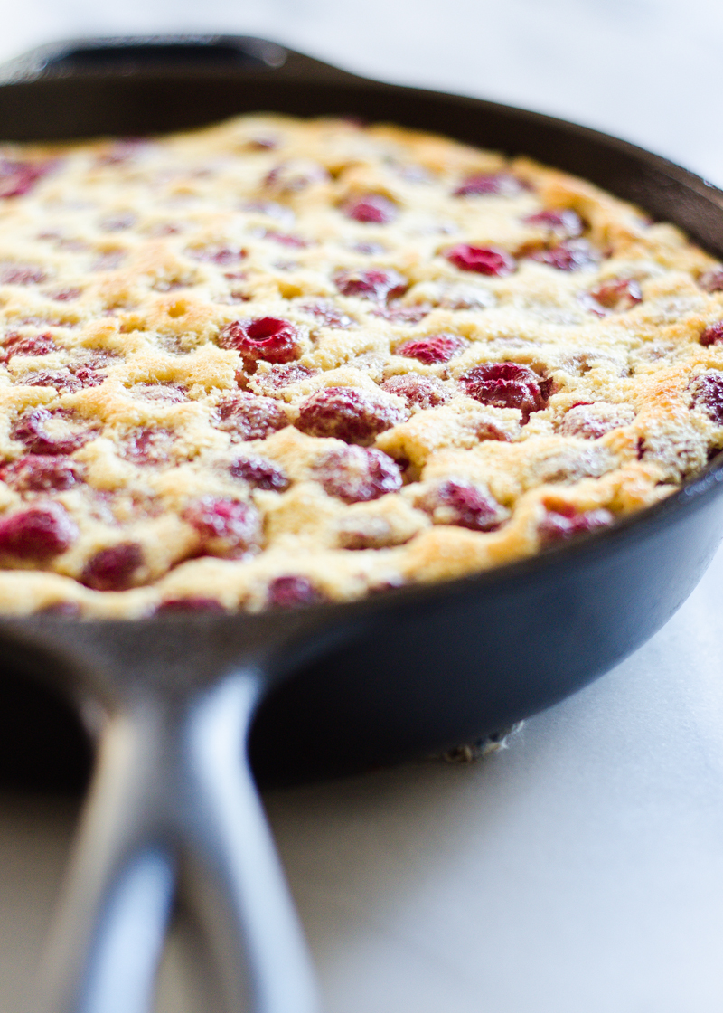 The baked Raspberry Clafoutis in a cast iron skillet.