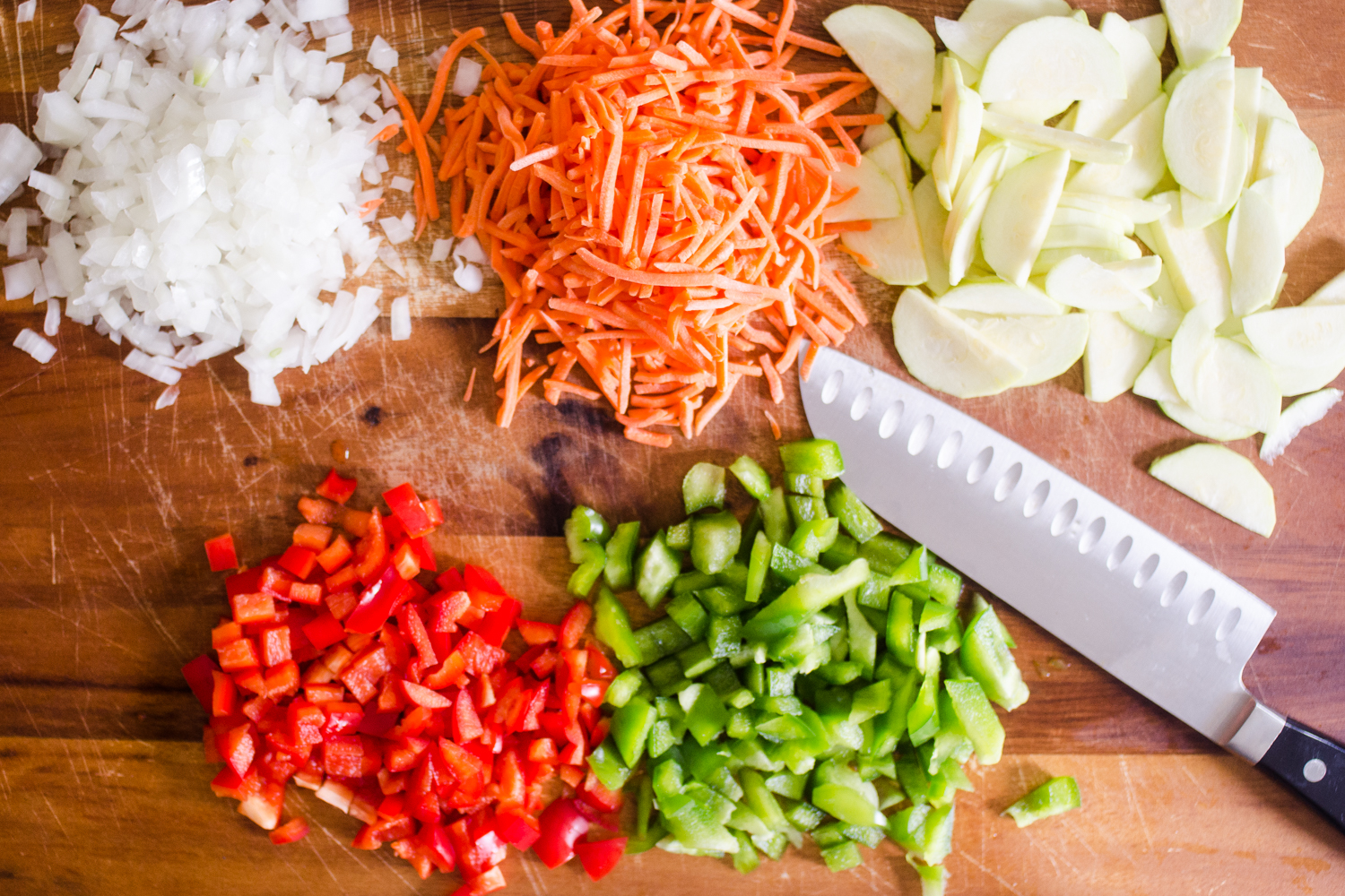 All of the vegetables prepared by chopping on a cutting board. 