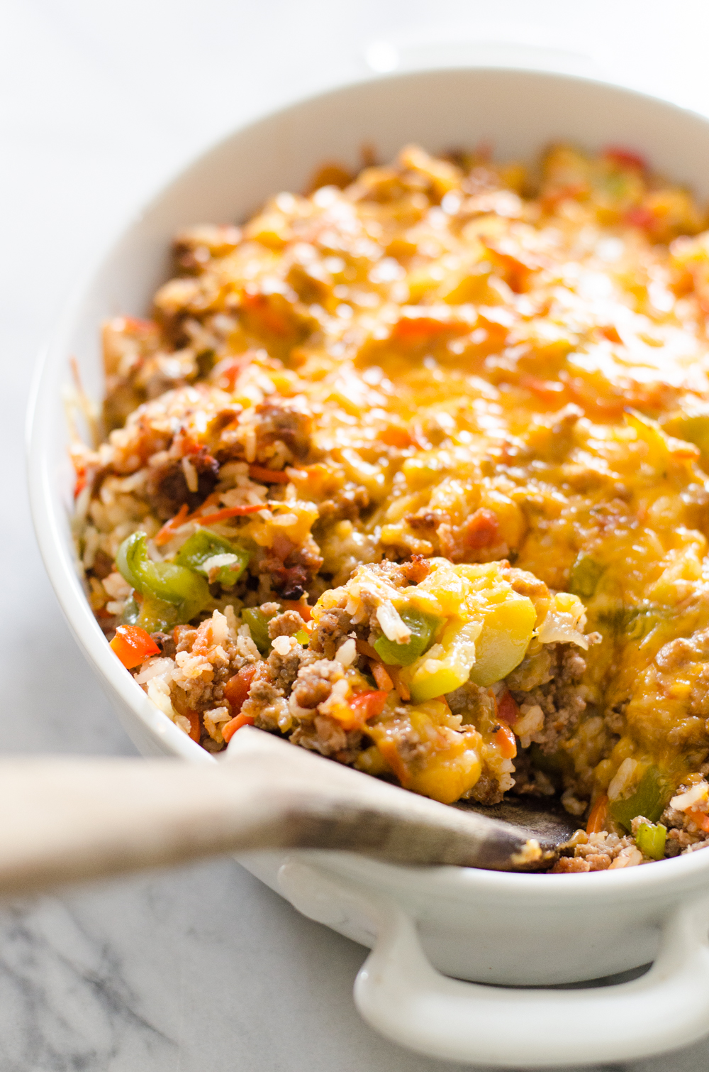 A pan of easy stuffed pepper casserole with a wooden server.