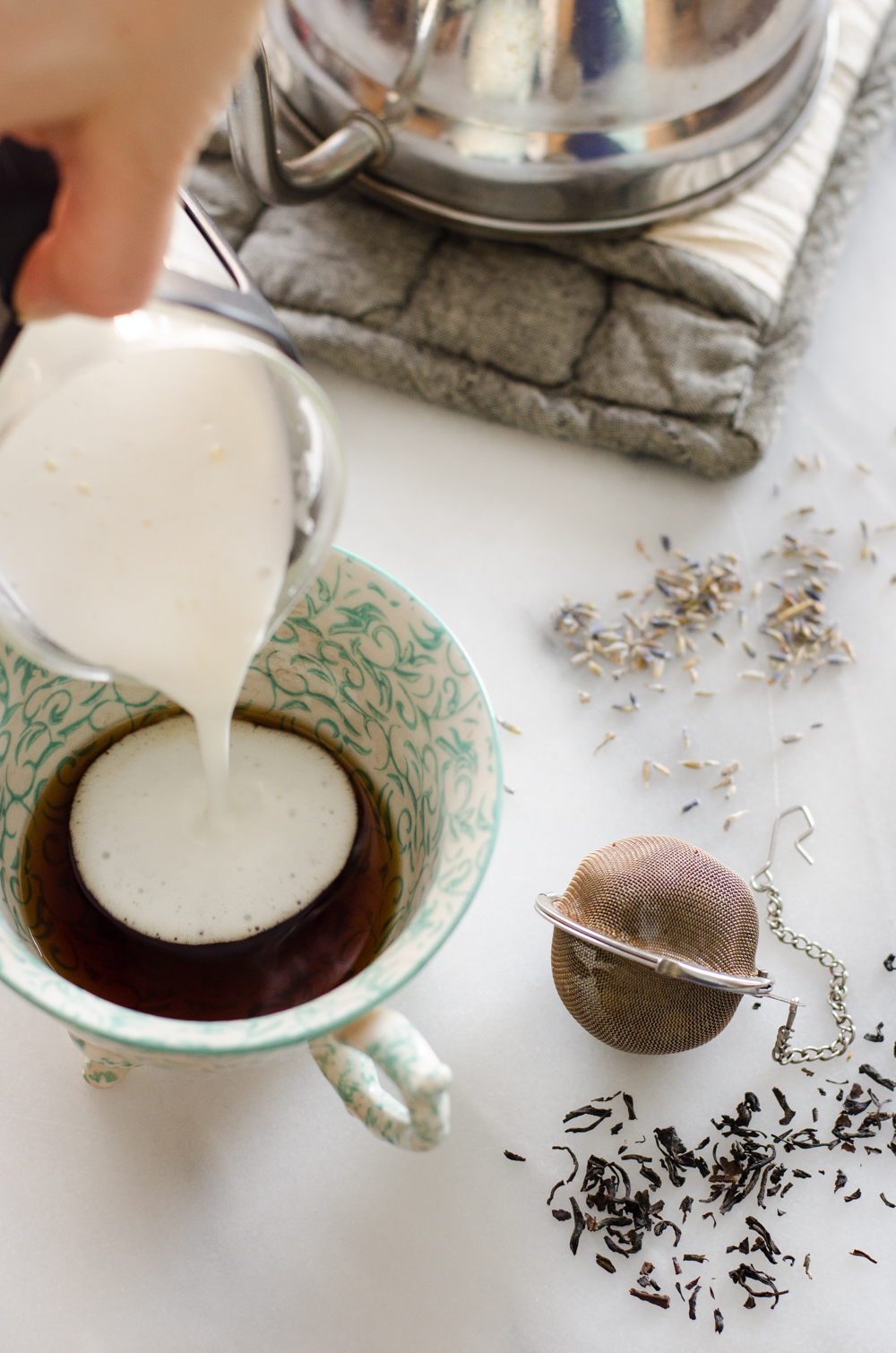 Heating the milk and cream in a pan and checking the temperature with a laser thermometer. 