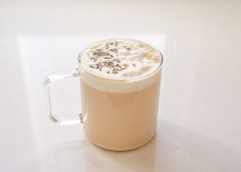 A London Fog Tea Latte in a clear glass mug.