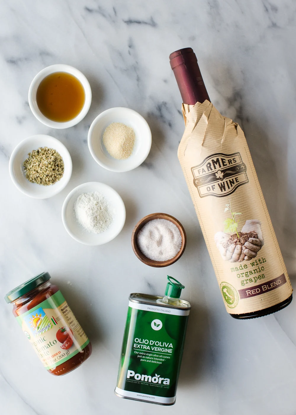 All of the ingredients needed for homemade pizza sauce from tomato paste.