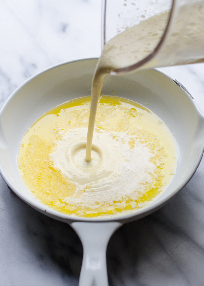 Pouring the batter into the hot, buttered pan.