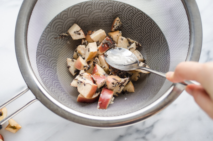 Pressing the apples through a fine mesh sieve to make a Spiced Apple Tea Latte