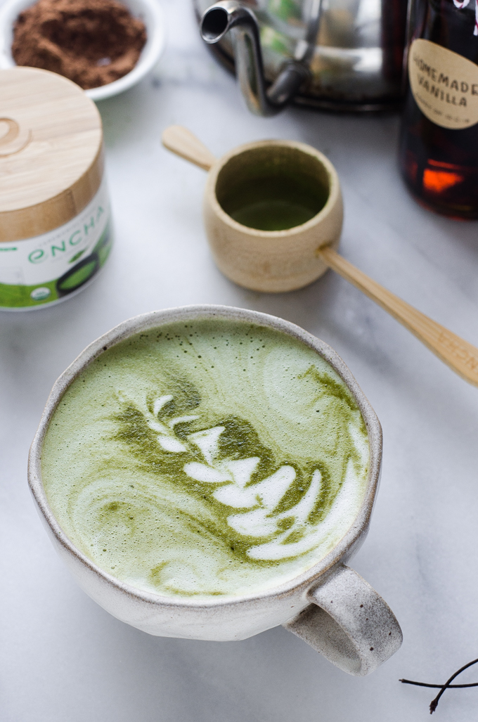 A mug of matcha hot chocolate made with cocoa powder.