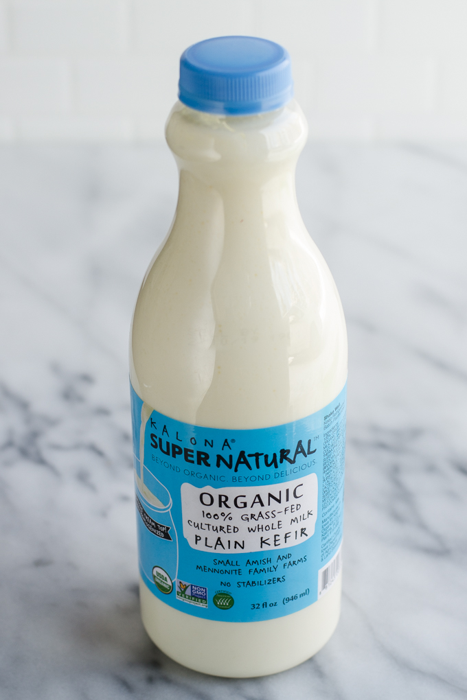 A bottle of Kalona SuperNatural grass-fed kefir on a marble surface. 