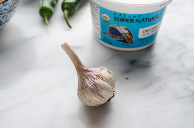 Photo of a bulb of garlic sitting on marble