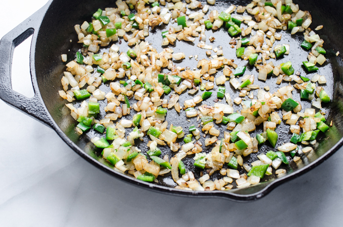 Cast iron skillet with sauteed onion and green peppers