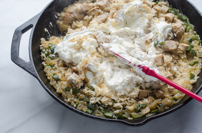 Stirring sour cream into the skillet