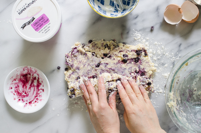 Rolling the scone dough up jelly-roll style.