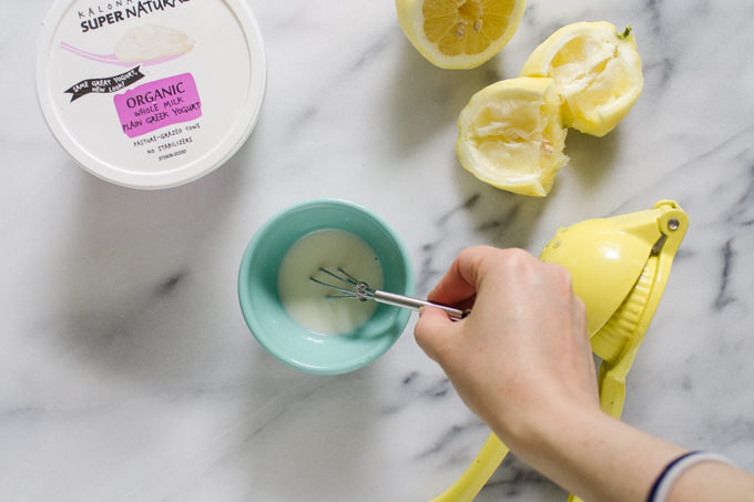 Whisking the Greek yogurt, lemon juice, and powered sugar together in a small bowl.