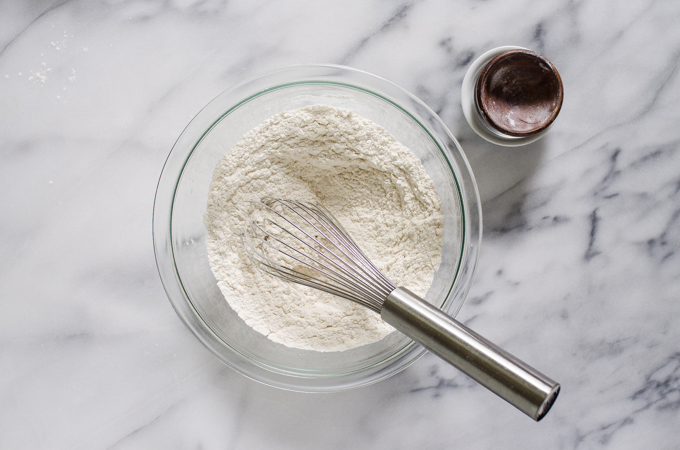 Dry ingredients in a bowl with a whisk.