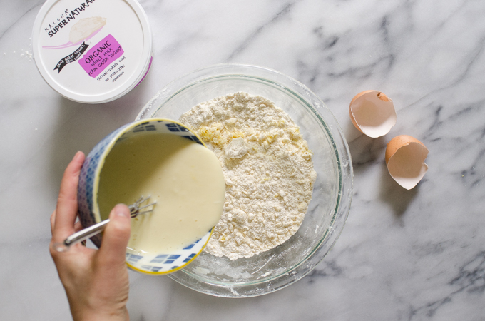 Pouring the wet ingredients into the dry ingredients.