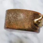 How to Polish Copper - Salt and ketchup on a tarnished copper pot.