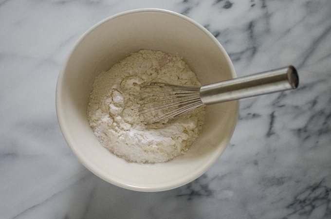 Whisking the dry ingredients together in a bowl.