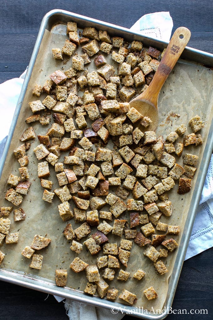 From above view of toasted croutons on a baking sheet.