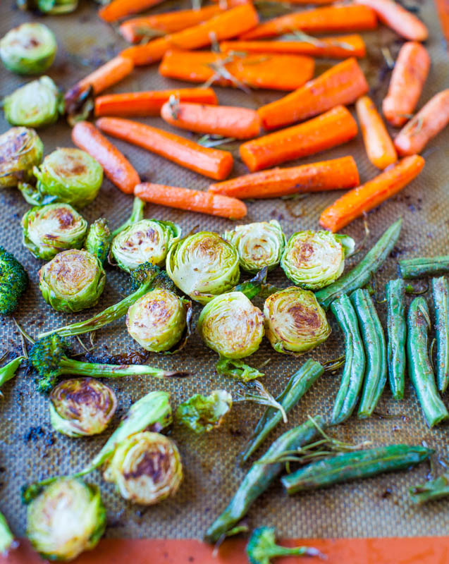 From above view of roasted vegetables on a silpat lined baking sheet.