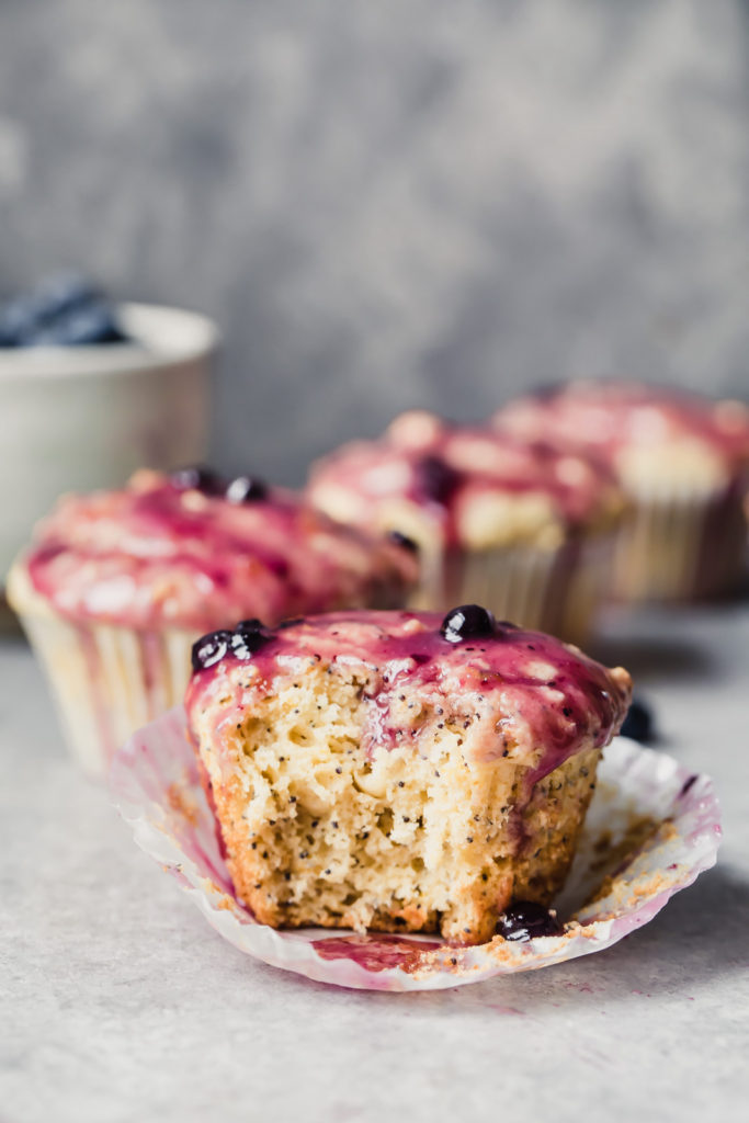 Photo of a lemon poppyseed muffin with a bite taken out of it.