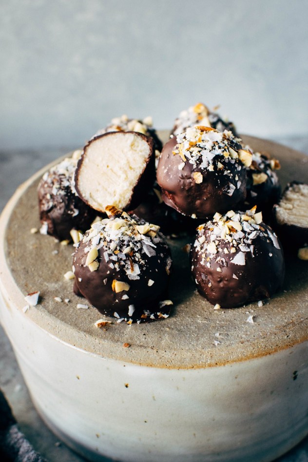 Coconut bliss balls with one cut in half.