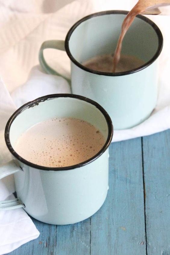 Coconut oil recipes: Mugs of cocoa, pouring into one.