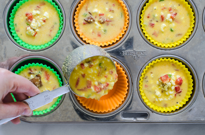 Pouring the batter into the muffin cups.