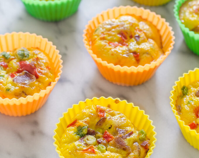 Several egg muffin cups on a marble surface.