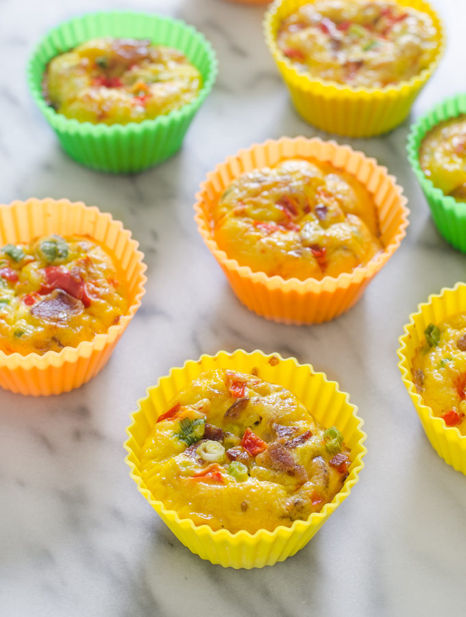 Several egg muffin cups on a marble surface.
