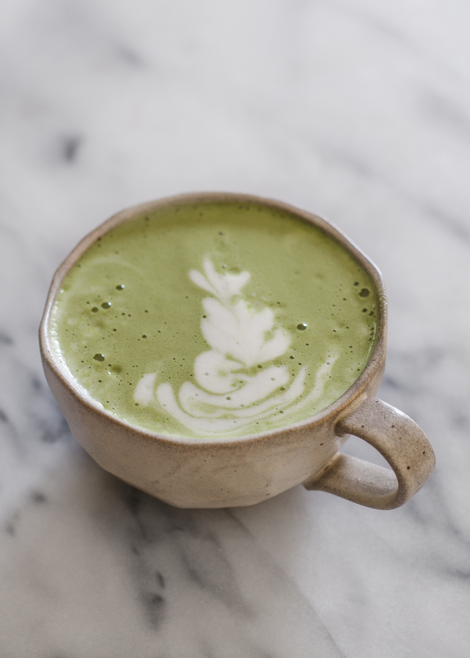 Matcha latte in a stoneware mug with latte art.