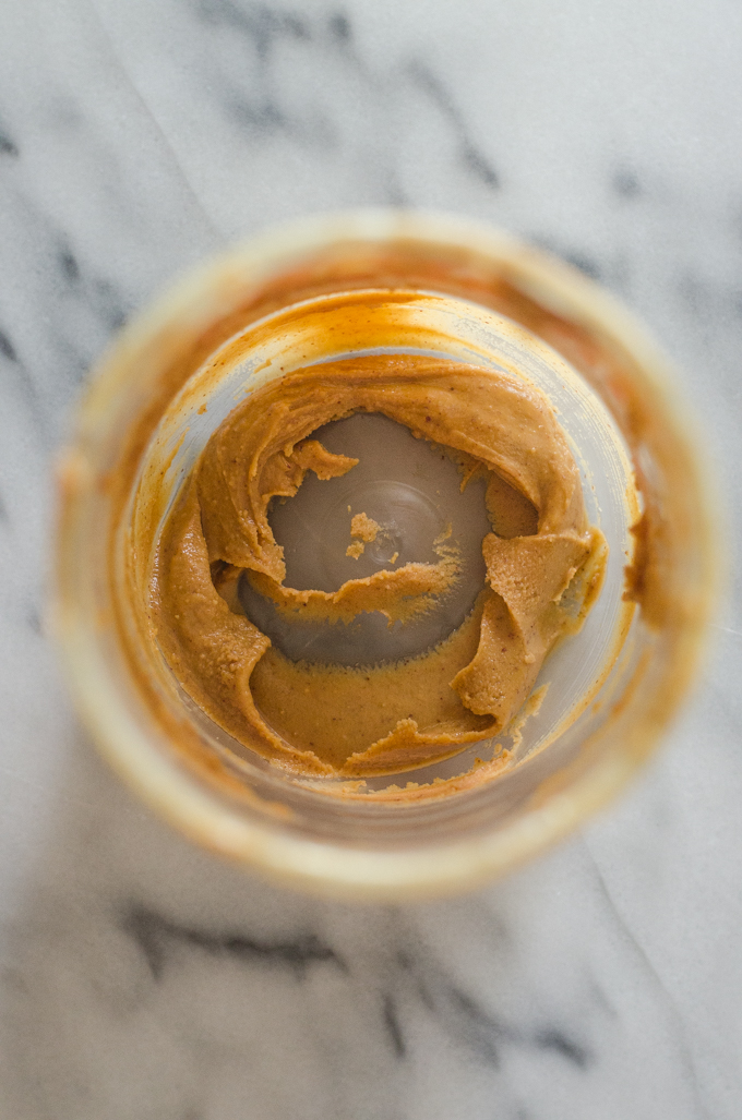 A nearly empty jar of peanut butter.