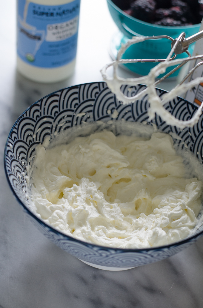 Homemade low carb whipped cream in a bowl with beaters.