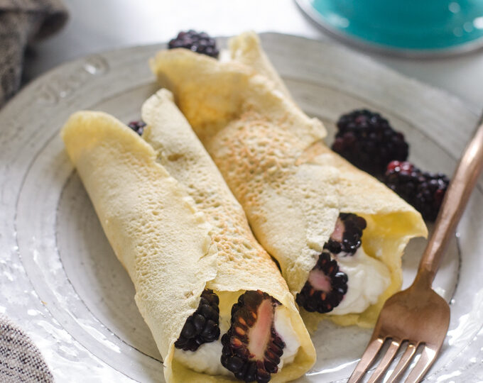 KETO crepes filled with whipped cream and blackberries.