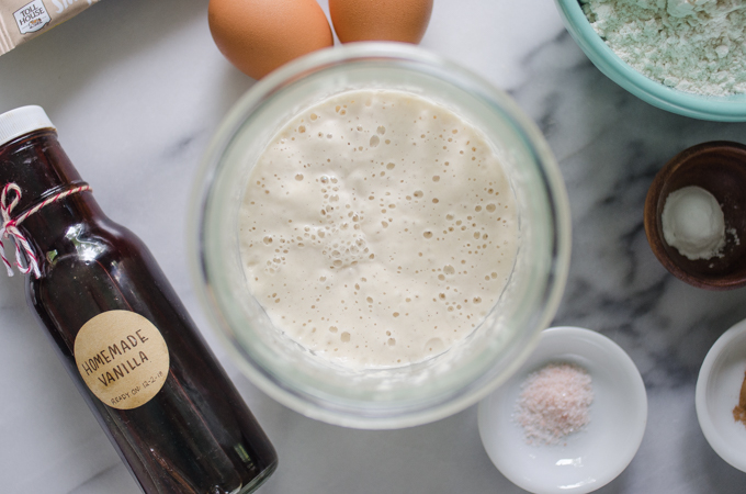 Active sourdough starter on a marble surface.