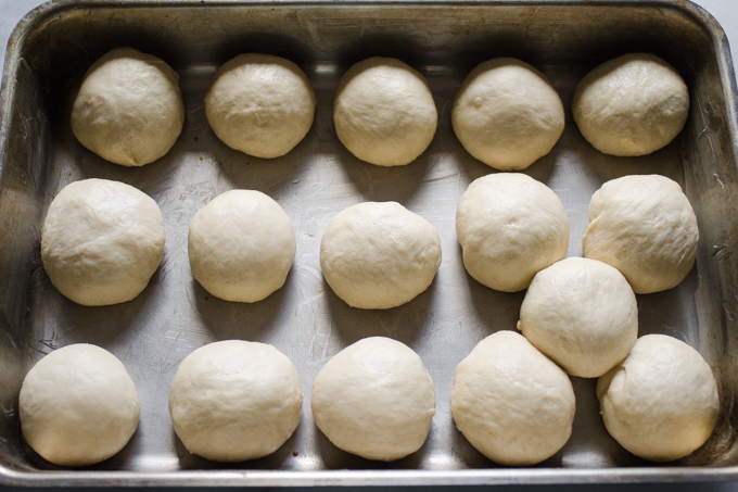 The balls of dough in a 13x9 inch stainless steel pan.