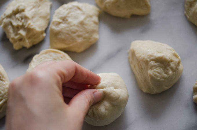 Pinching the edges of the dough together.