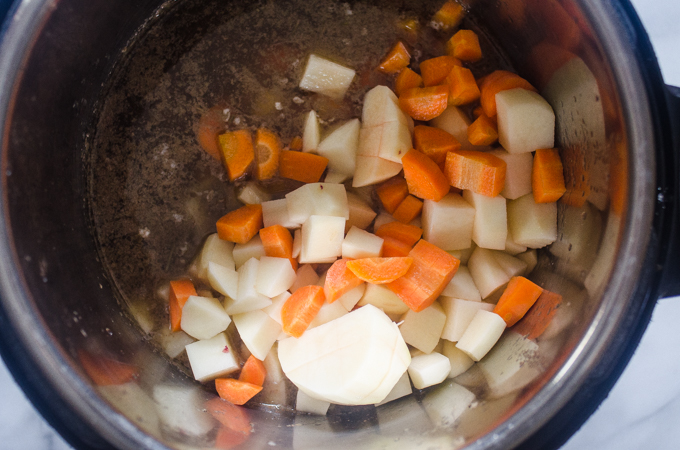 Adding the vegetables to the Instant Pot Beef Stew.