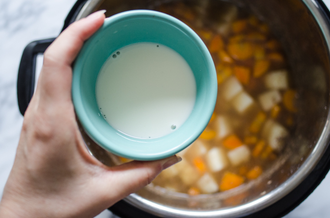 Adding cornstarch to the stew.