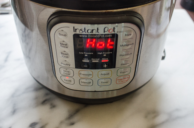 An Instant Pot set to saute with "Hot" being displayed.