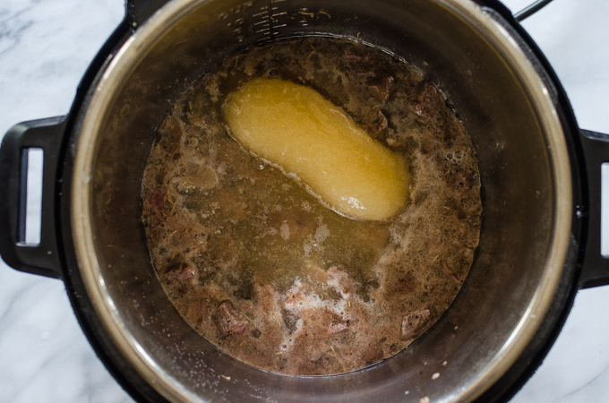 Adding the broth to the Instant Pot.