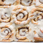 The finished eggnog cinnamon rolls from above in the pan.