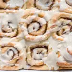 The finished eggnog cinnamon rolls from above in the pan.