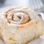 Close up shot of one of the eggnog cinnamon rolls on a plate.