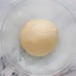 The ball of dough in a buttered bowl.