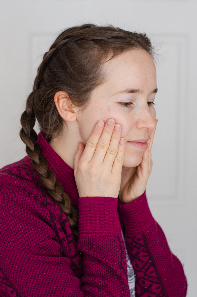 Applying skincare products to my face for my 5 step winter skin care routine for dry skin.